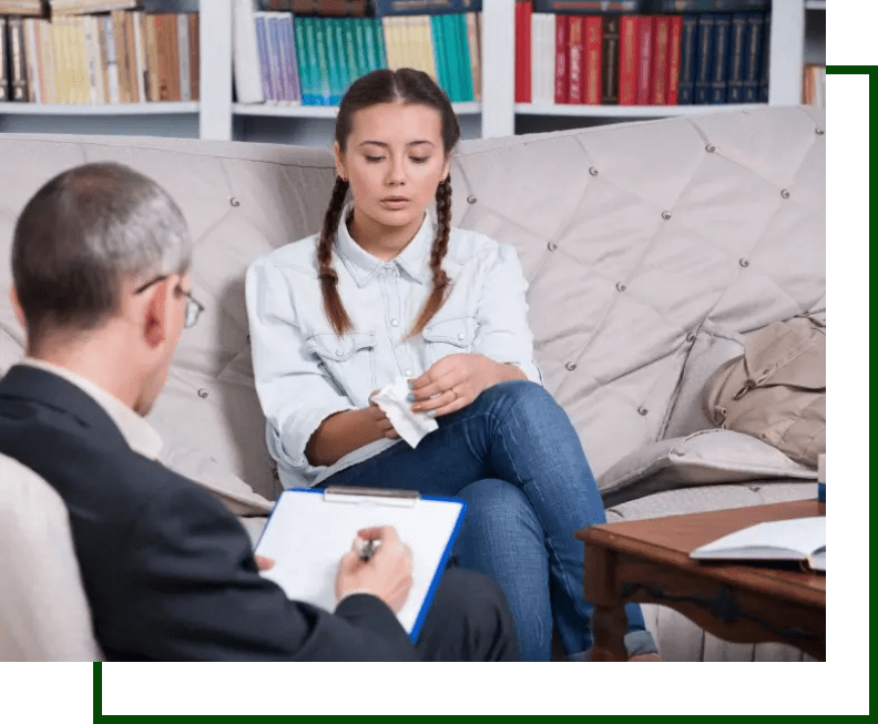 A woman sitting on the couch with an older man.