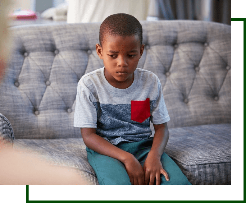 A young boy sitting on top of a couch.