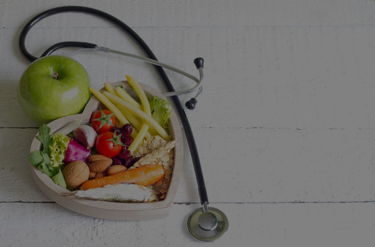 A stethoscope sitting on top of a table next to food.