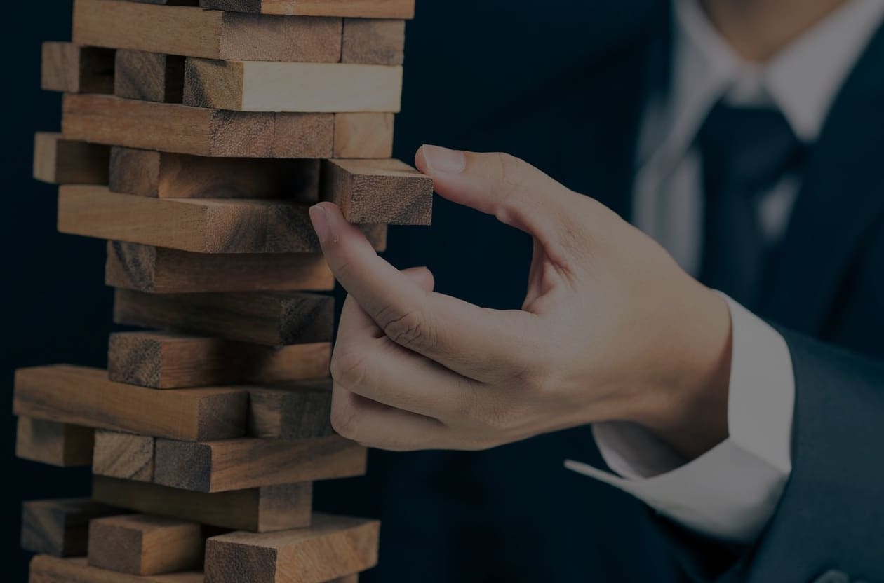 A person playing with wooden blocks in front of them.