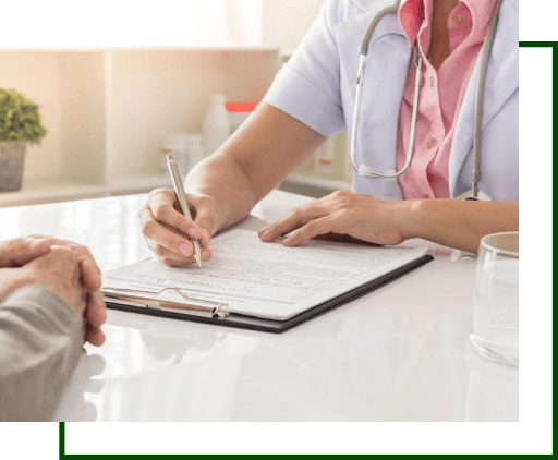 A doctor is writing on the paper while talking to someone.