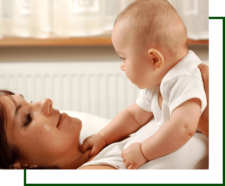 A woman holding a baby in her arms.