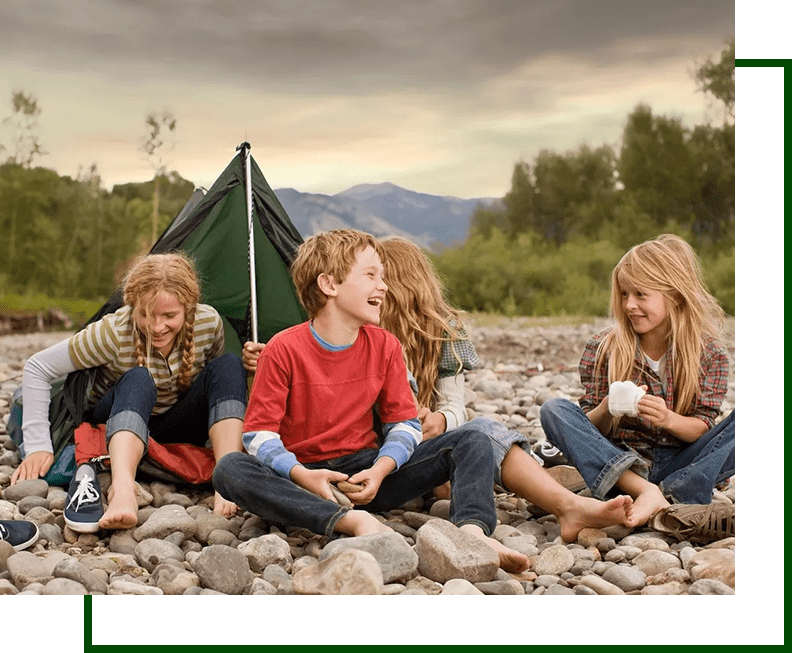 A group of kids sitting on the ground